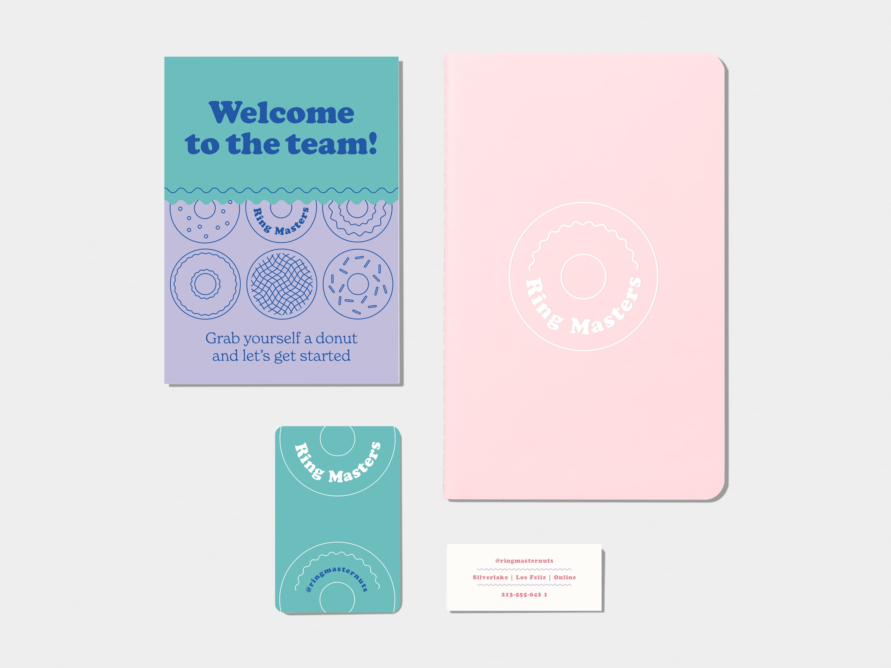 A flyer on the top left corner. Pastel Pink soft cover journal with silver foil pattern in top right corner. A business card on bottom left corner. A mini card on bottom right corner.