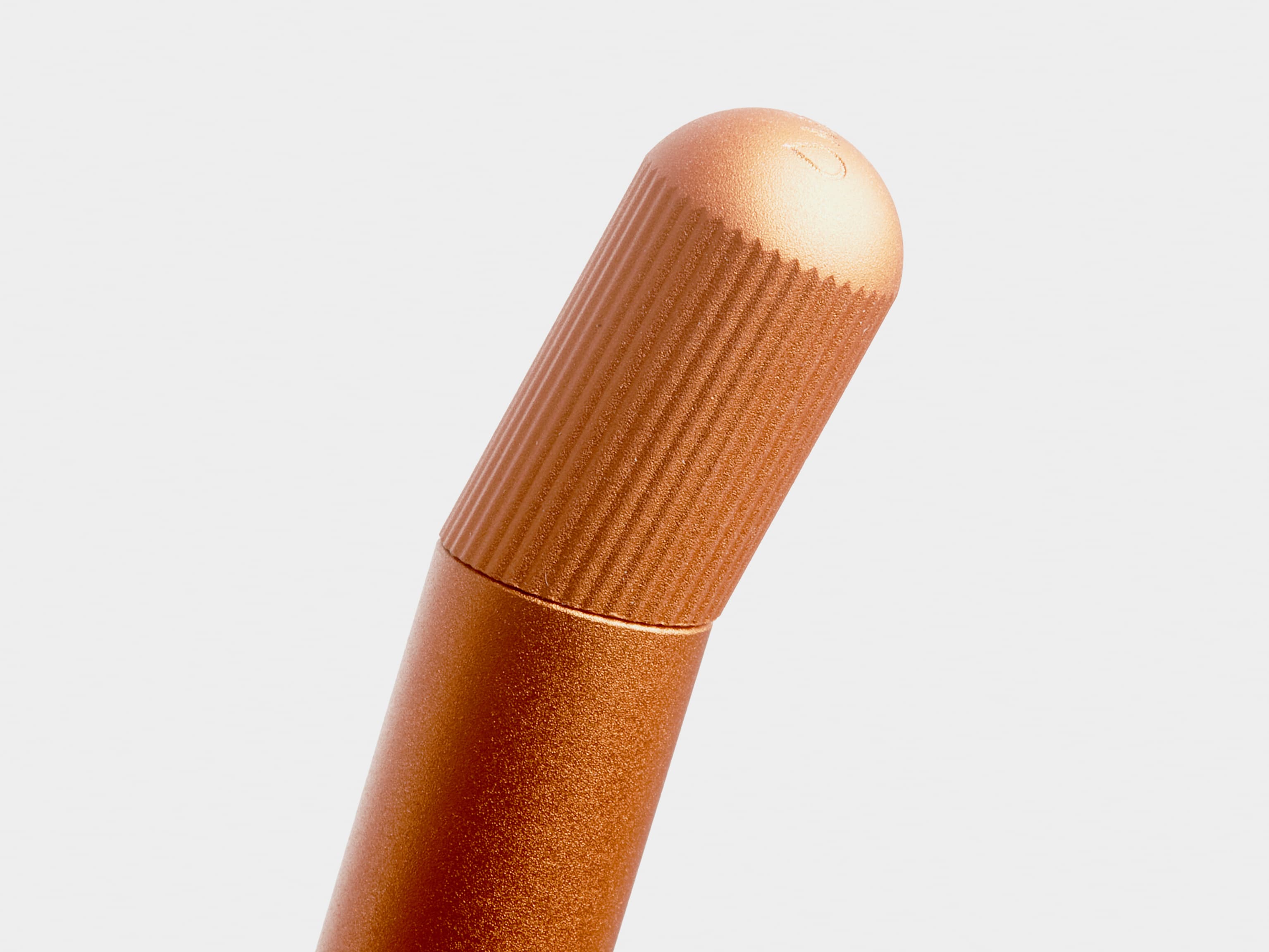 Close up of the top of a orange pen.