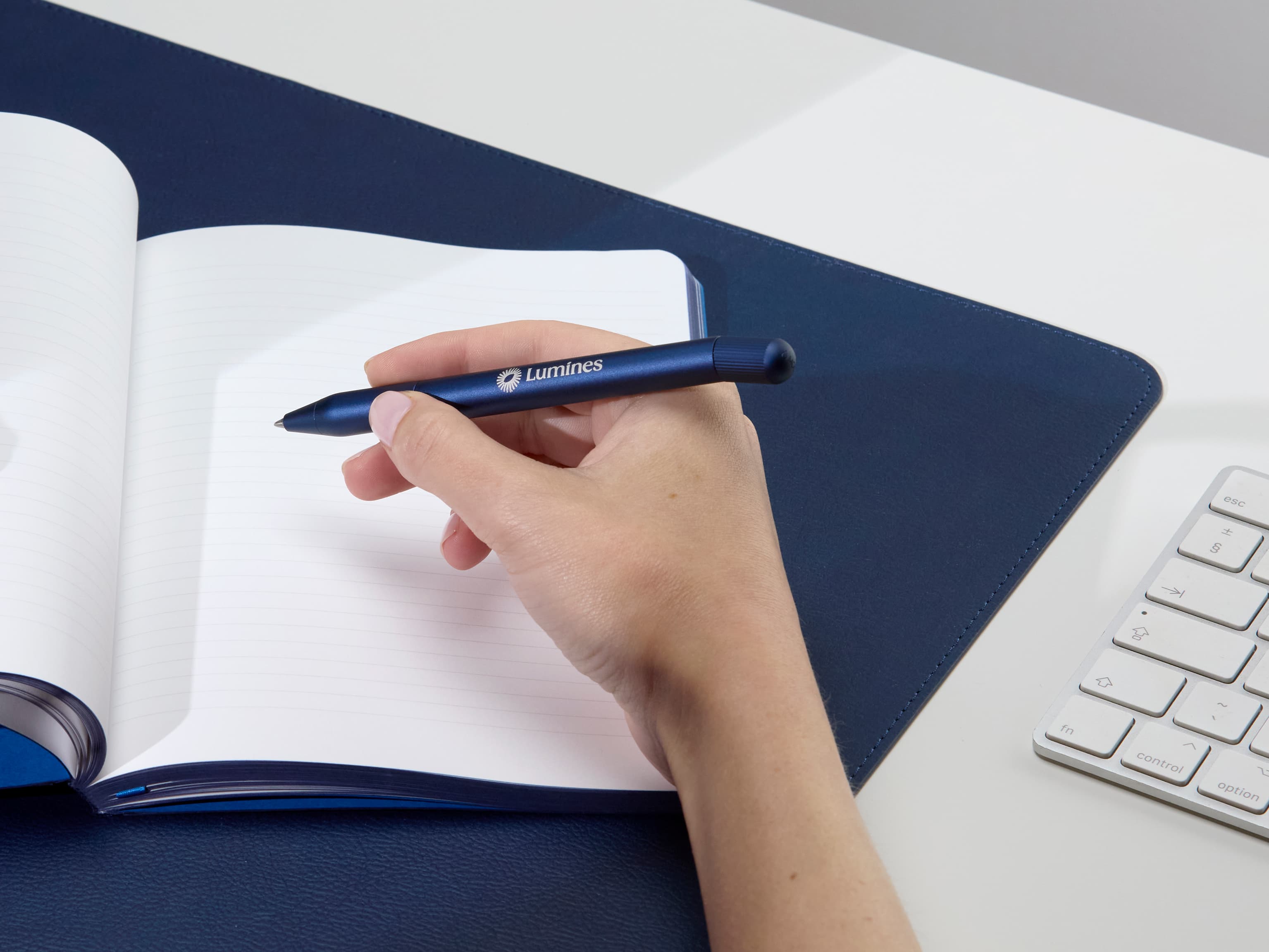 A person holding a custom blue pen.