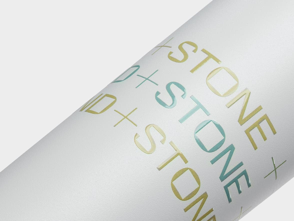 Detailed image of cloud grey water bottle with custom gold and blue branding.