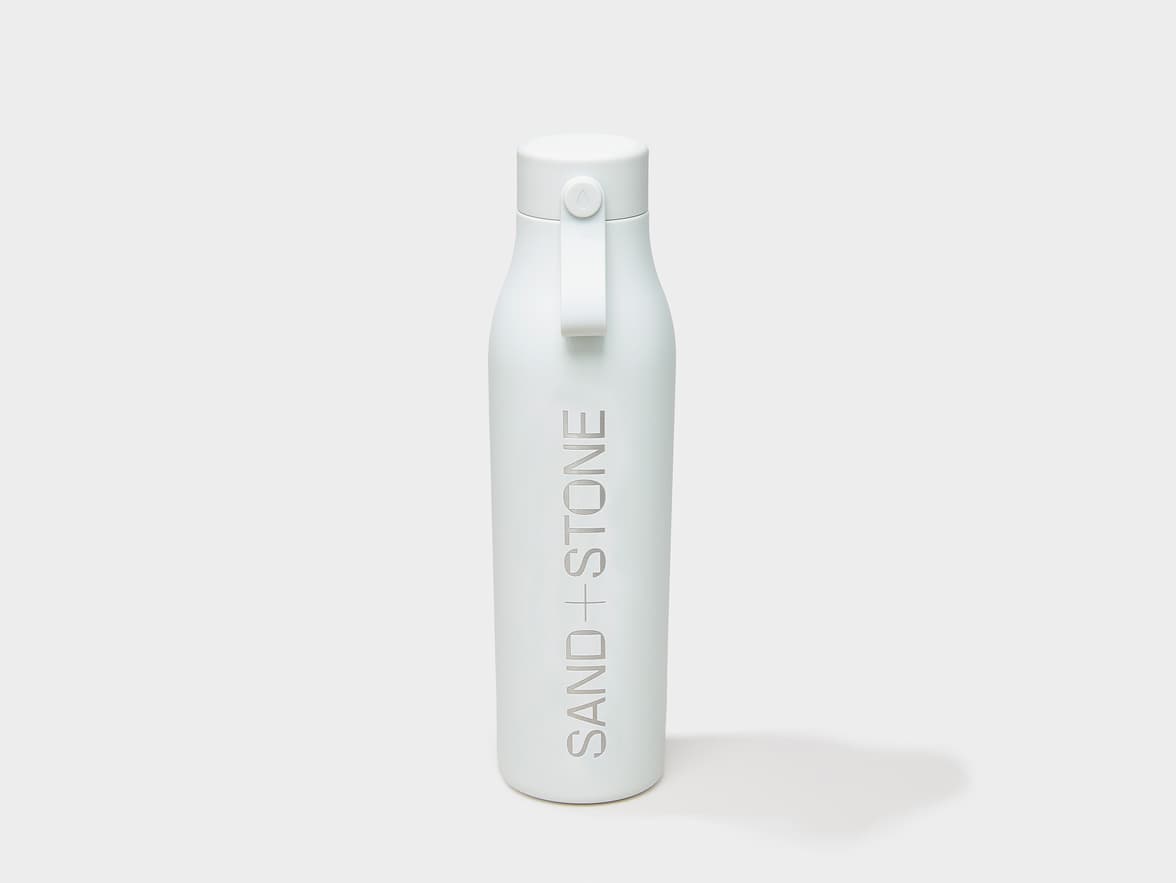 A cloudy grey MOO water bottle with custom engraving.