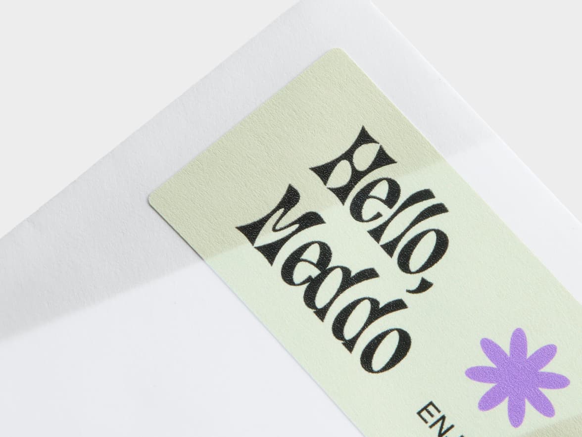 A detailed image of the corner of a matte paper sticker.
