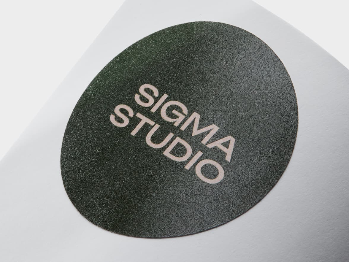 A close up of a dark green customized round coated sticker.